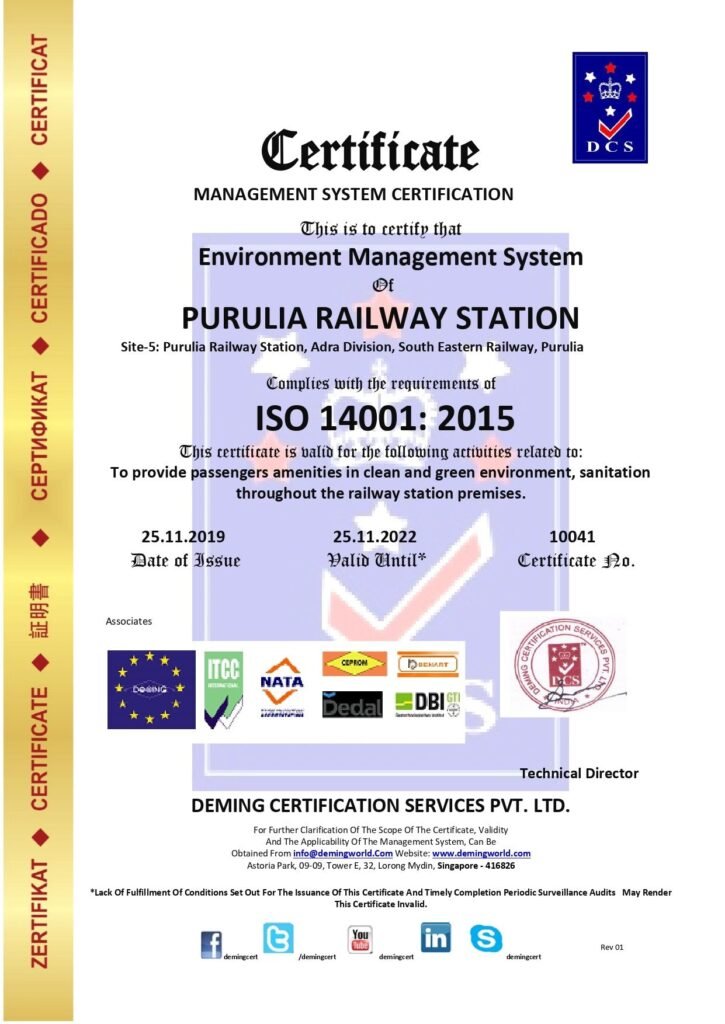 Management System Certificate issued by Deming Certification Services Pvt. Ltd. certifying Purulia Railway Station (Adra Division, South Eastern Railway, Purulia) for ISO 14001:2015 Environment Management System compliance, featuring a vertical gold margin on the left and international accreditation logos along the bottom.